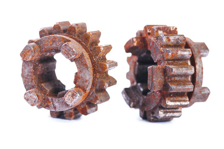 very old dusted and rusted machine cogwheels isolated on white backgroundの写真素材