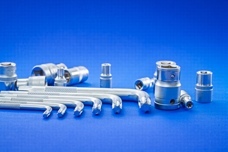 automobile torx and hexagonal keys on blue background close up