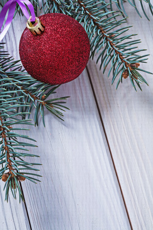 copyspace image christmas ball on white boards and branch of pinetreeの写真素材