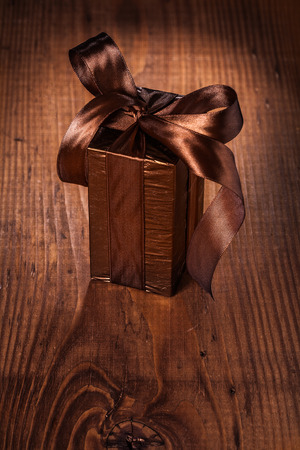 brown giftbox on old wooden boardの写真素材
