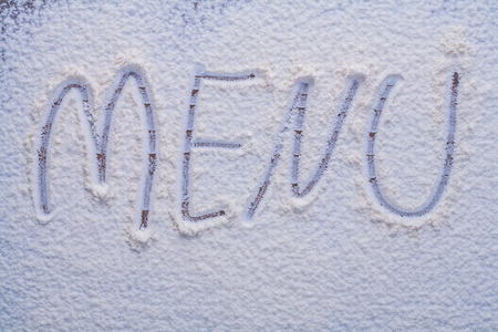 Handwritten inscription menu is made with flour food and drink の写真素材