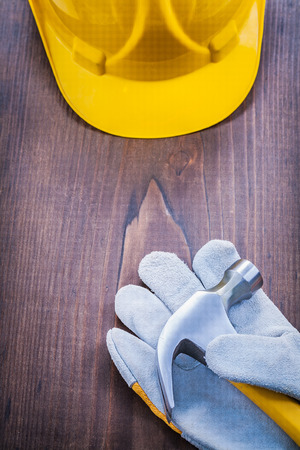 claw hammer glove helmet on vintage wooden boardの写真素材