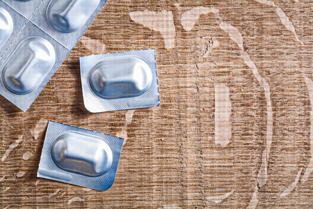 medical pills on wooden board