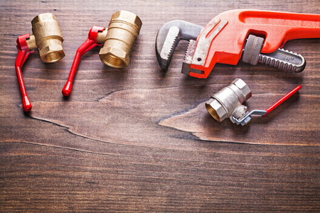 organized copyspace plumbing fixtures monkey wrench on vintage wの写真素材