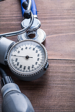 blood pressore monitor stethoscope on vintage wooden board medicの写真素材