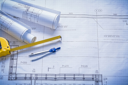 two rolled blueprints tapeline compass with copyspace constructiの写真素材