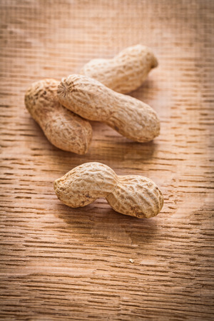four peanuts on vintage wooden board food and drink conceptの写真素材