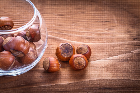 hazelnuts in glass on vintage wooden board food and drink coの写真素材