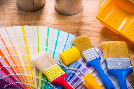 very close up view paint brushes roller tray on wooden boardの写真素材