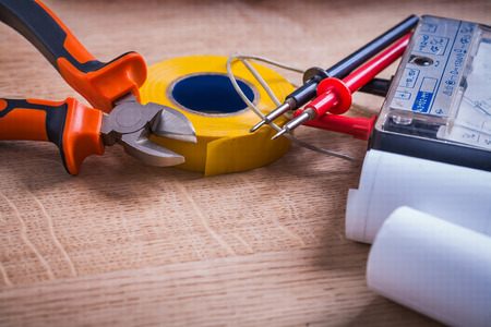 nippers roll of insulating tape multimeter and blueprints On Woodenの写真素材