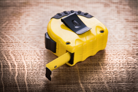 yellow tape measure on wooden board construction conceptの写真素材