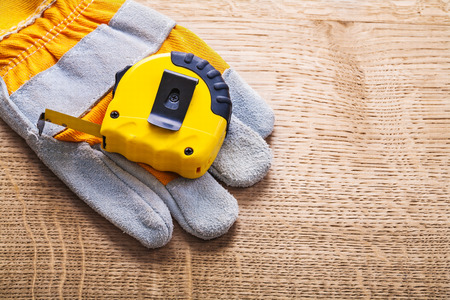 horizontal version tapeline and protective working glove on wood