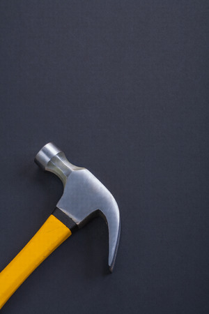 vertical version claw hammer with yellow handle on black backgroの写真素材