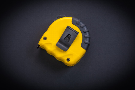 yellow tapeline on black backgroundの写真素材