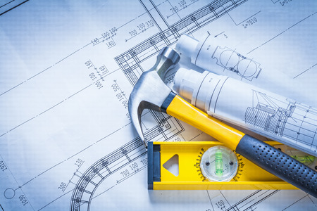 Claw hammer rolls of blueprints construction level building andの写真素材