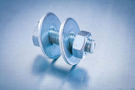 Metal screwbolt with bolt washers and construction nut on metallの写真素材