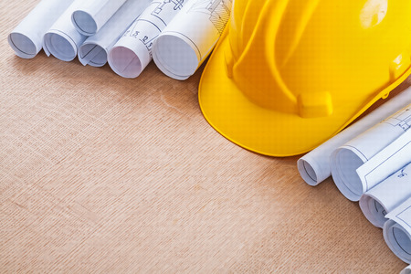 Oaken wooden board with building helmet and pile of constructionの写真素材