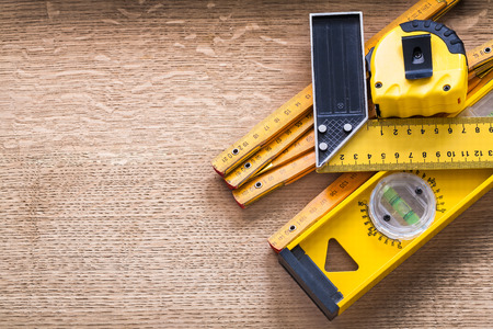 Working tools of measurement on oaken wooden board construction