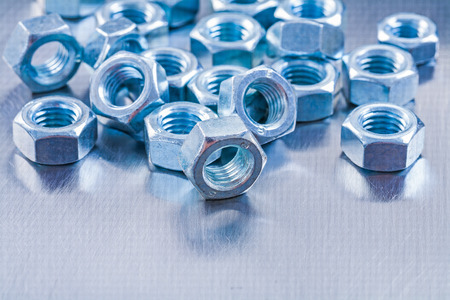 Collection of stainless screw nuts on metallic background の写真素材