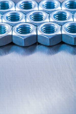 Copy space image of stainless screw nuts on metallic backgroundの写真素材