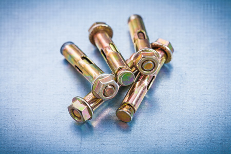 Metal anchor bolts for concrete walls on metallic background の写真素材