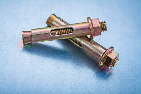 Some anchor bolts for concrete walls on metallic background の写真素材