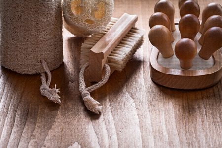 Scrubbing brush loofahs and back massager on pine vintage wood board healthcare conceptの写真素材