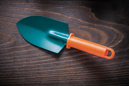 Hand gardening spade on vintage wood board agriculture concept.の写真素材