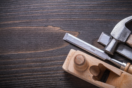 Copy space image of claw hammer planer and firmer chisels on vintage wooden board construction concept.の写真素材
