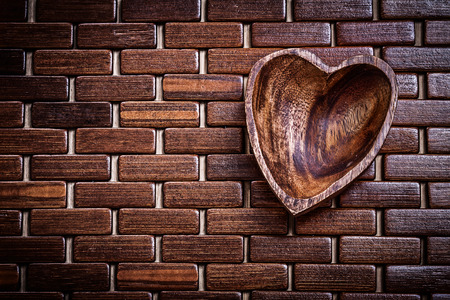 Heartshaped bowl on wooden matting food and drink concept.の写真素材