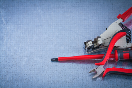 Insulated screwdriver electricians tape automatic wire strippers construction concept.