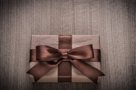 Wrapped vintage present box with tied brown bowの写真素材