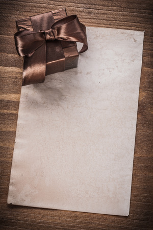 Glittery giftbox paper on vintage wooden board.の写真素材