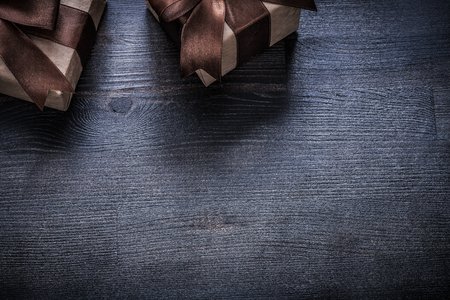 Wrapped gift containers on vintage wood board holiday concept.の写真素材