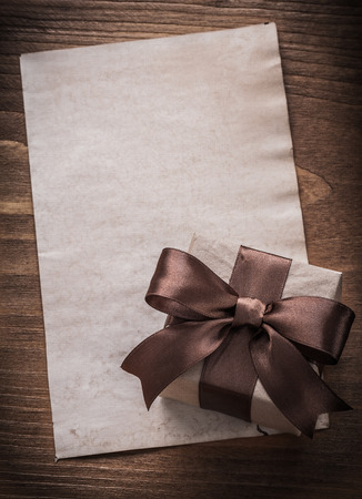 Packed gift box paper on vintage wooden board holiday concept.の写真素材