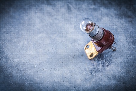Electric lamp holder on scratched metallic background electricity concept.の写真素材