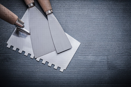 putty knife and two paint scrapers on vintage wood.の写真素材