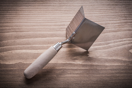 hand angle former with wooden handle on wood board.の写真素材