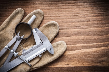 Vernier scale drawing compass leather safety gloves construction concept.の写真素材