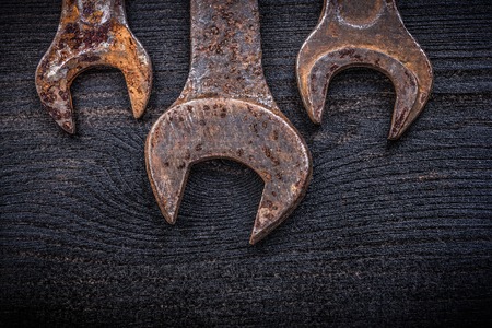 Collection of rusted spanner wrenches on wood board construction concept.の写真素材