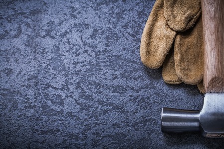 Leather safety gloves claw hammer on black background copy space.の写真素材