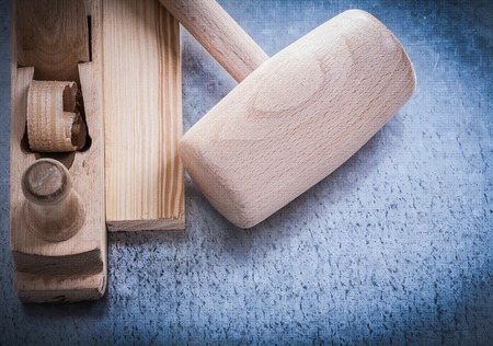 Planer lump hammer wooden brick on metallic background construction concept.の写真素材