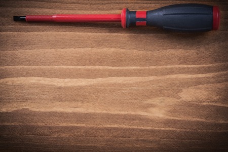 Insulated screwdriver on wooden board electricity concept.の写真素材