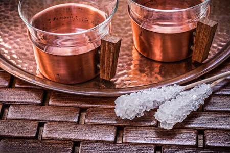 Close up view of coppery tray tea cups sugar sticks.の写真素材