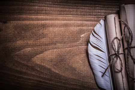 Antique rolled up paper plume on wood board copy space.の写真素材
