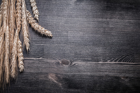 Composition of wheat and rye ears on vintage wooden board.の写真素材