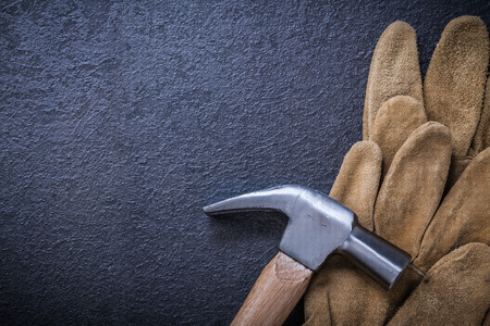 Top view of leather safety gloves claw hammer construction concept.