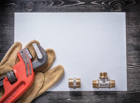 Pipe wrench brass plumbing fittings leather safety gloves blank paper.の写真素材