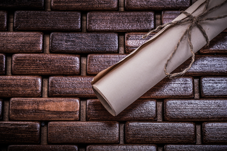 Vintage rolled paper on wicker wooden mat.