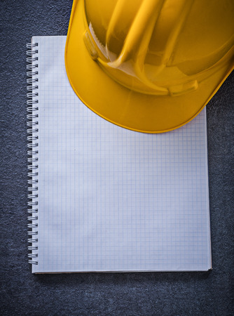Notebook building helmet on black background construction concept.の写真素材